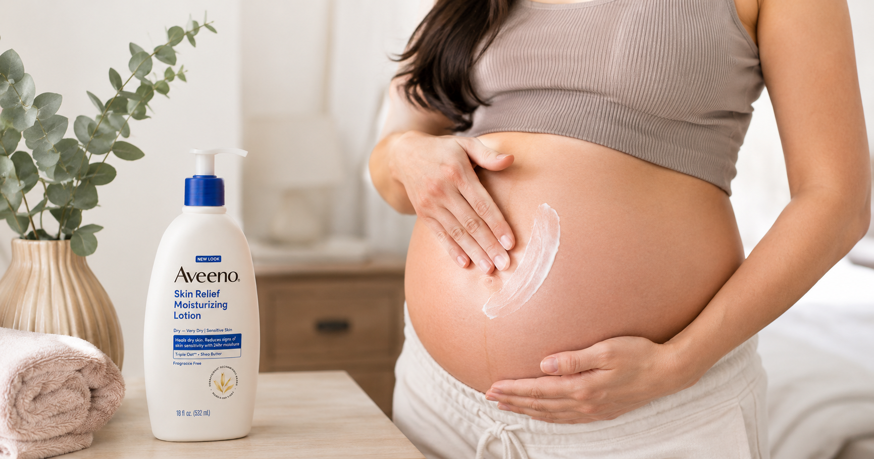 Pregnant woman applying Aveeno lotion to her bump